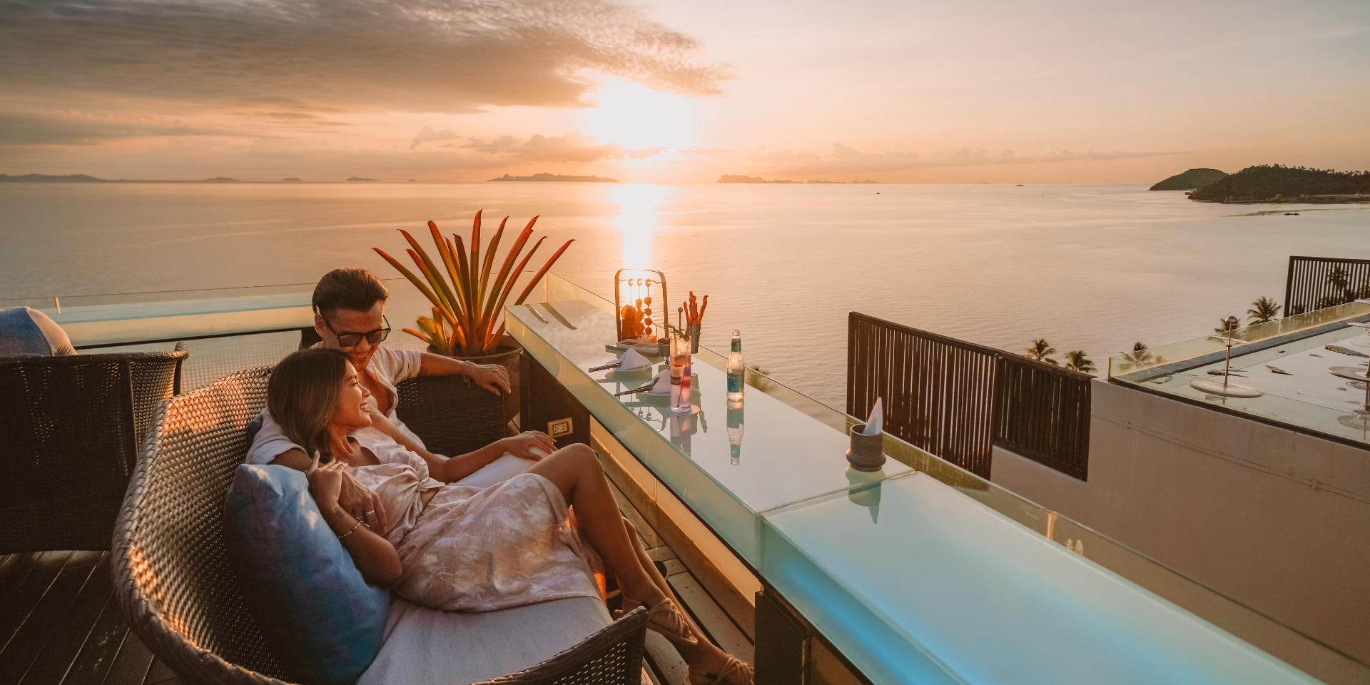 Couple watching sunset over the Gulf of Thailand